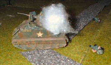 The aftermath of battle: a burning A.P.C. and abandoned Australian dead