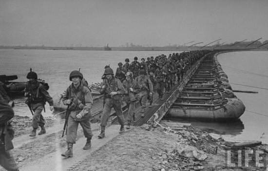 American soldiers of 75th Division cross the Rhine River on a M2 pontoon bridge