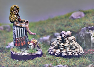 Babd Macha collector of heads (CM24-03) next to the new Skull Pile
