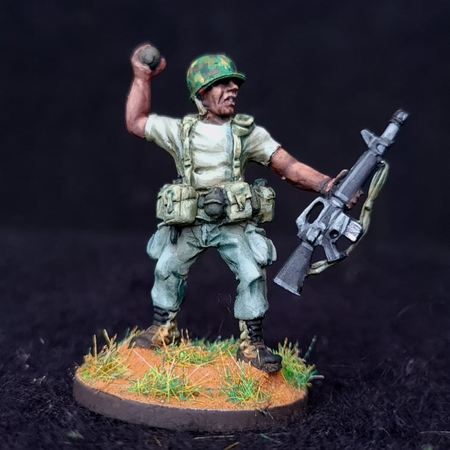 U.S. Army African-American soldier in the process of throwing a fragmentation grenade