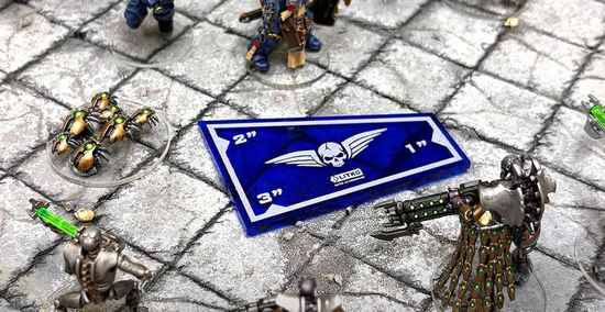 Litko translucent blue 3-inch Combat Gauge resting between miniatures on a battlefield mat