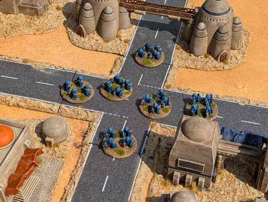 Riot control units spread out from a central crossroads