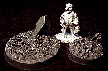 Both sizes of Crystal Bases, posing with a 25mm-tall Reaper figure to show scale