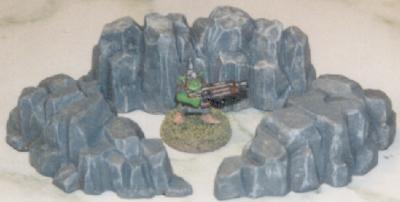 Gretchin posed among finished rock outcroppings