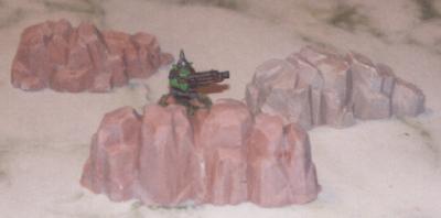 Gretchin posed among unpainted rock outcroppings